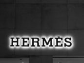 A black and white photo of a building with a neon sign