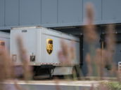 A truck is parked in front of a building