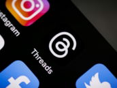 a close up of a cell phone with social icons